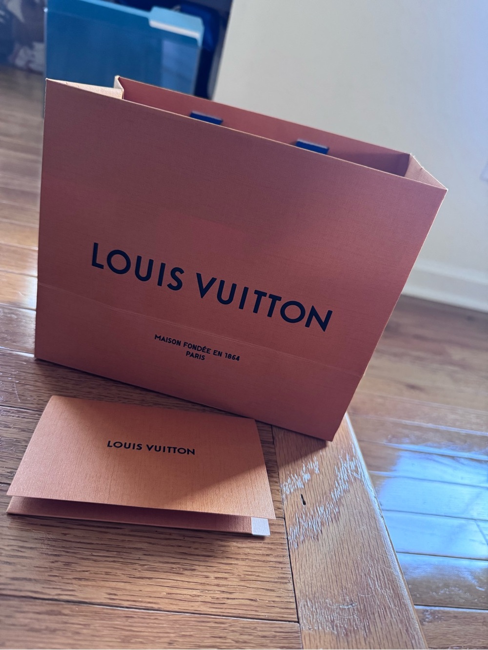 Louis Vuitton orange shopping bag with blue handles